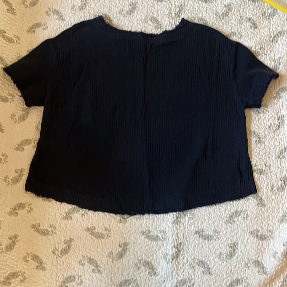 We the Free size M boxy washed black woven top w/ pocket and frayed hems.